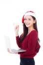 Portrait of beautiful asian young woman in santa hat using laptop Royalty Free Stock Photo