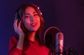 Portrait of beautiful asian young woman singer with headphone and microphone Royalty Free Stock Photo