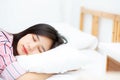 Portrait of beautiful asian young woman sleep lying in bed with head on pillow comfortable and happy with leisure. Royalty Free Stock Photo