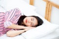 Portrait of beautiful asian young woman sleep lying in bed with Royalty Free Stock Photo