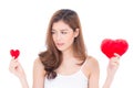 Portrait of beautiful asian young woman smiling holding red heart shape pillow choice big and small isolated Royalty Free Stock Photo