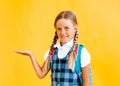 Portrait of beautiful attractive lovely cheerful cheerful girl schoolgirl in white shirt with object advertisement isolated on Royalty Free Stock Photo