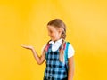 Portrait of beautiful attractive lovely cheerful cheerful girl schoolgirl in white shirt with object advertisement isolated on Royalty Free Stock Photo