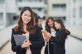 Portrait of a beautiful authentic satisfied business woman looking at camera with team at behind. Concept for leadership and succe