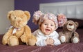 Portrait of a beautiful baby with plush toys Royalty Free Stock Photo