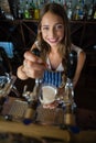Portrait of beautiful barmaid pouring beer from tap in glass Royalty Free Stock Photo