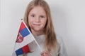 Portrait beautiful blond girl with the flag of Serbia. Football or soccer team fan, sport event and patriotism concept. Royalty Free Stock Photo