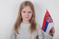 Portrait beautiful blond girl with the flag of Serbia. Football or soccer team fan, sport event and patriotism concept. Royalty Free Stock Photo
