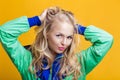 Portrait of beautiful blond woman in casual colorful vivid green summer clothes on yellow background Royalty Free Stock Photo