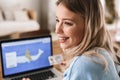 Portrait of beautiful blond woman 20s using laptop and credit card for online shopping indoor Royalty Free Stock Photo