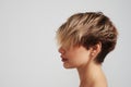 Beautiful blond woman with short hairstyle posing at studio