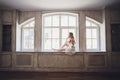 Portrait of a beautiful blonde bride in the interior. Morning young bride in a bathrobe. Wedding photography. Smiling