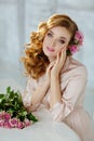 Portrait of a beautiful blonde girl with delicate pink roses on Royalty Free Stock Photo