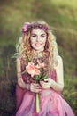 Portrait of a beautiful blonde girl in a pink dress