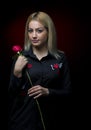 Portrait of a beautiful blonde girl with a red rose in her hand isolated Royalty Free Stock Photo