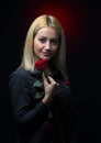 Portrait of a beautiful blonde girl with a red rose in her hand isolated Royalty Free Stock Photo