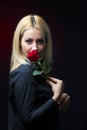 Portrait of a beautiful blonde girl with a red rose in her hand isolated Royalty Free Stock Photo