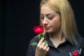 Portrait of a beautiful blonde girl smelling a red rose isolate Royalty Free Stock Photo