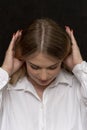 Portrait of a beautiful blonde girl 20-25 years old with long hair on a dark background. Royalty Free Stock Photo