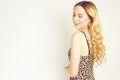 Portrait of a beautiful blonde with long hair. Girl with gold earrings, costume jewelry, dress with leopard print. Young girl with Royalty Free Stock Photo