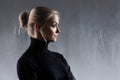 Portrait of beautiful blonde woman. Calm and self-confidence. Beautiful adult girl in black turtleneck, gray background
