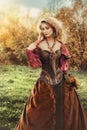 Portrait of a beautiful blonde woman in a historical costume in nature, Royalty Free Stock Photo