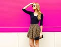 Portrait beautiful blonde woman model posing in leopard skirt, sunglasses with handbag clutch Royalty Free Stock Photo