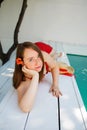 Portrait of a beautiful blonde woman outdoor near swimming pool wearing a red dress Royalty Free Stock Photo