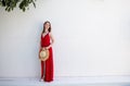 Portrait of a beautiful blonde woman outdoor near swimming pool wearing a red dress Royalty Free Stock Photo