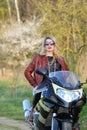 Portrait of a beautiful blonde woman on a sports motorcycle Royalty Free Stock Photo