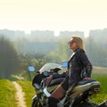 Portrait of a beautiful blonde woman on a sports motorcycle Royalty Free Stock Photo