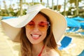 Portrait of beautiful blonde woman with straw hat and sunglasses having fun at beach. Funny dreaming girl in her summer holidays. Royalty Free Stock Photo