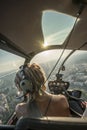 Portrait of beautiful blonde women enjoying helicopter flight. She is amazed by cityscape