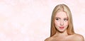 Portrait of beautiful blonde young woman face.  Spa model girl with fresh clean skin isolated on a blur pink background Royalty Free Stock Photo