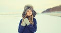 Portrait of beautiful blonde young woman posing in winter hat outdoors Royalty Free Stock Photo