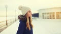 Portrait of beautiful blonde young woman posing in winter hat outdoors Royalty Free Stock Photo