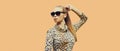 Portrait of beautiful blonde young woman wearing leopard dress and sunglasses on background Royalty Free Stock Photo