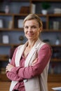 Portrait of beautiful blondie woman looking at camera and smiling. Adult stylish businesswoman at workplace in office