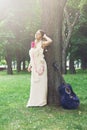 Portrait of beautiful boho girl near tree with blue guitar Royalty Free Stock Photo