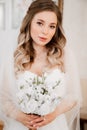 portrait of a beautiful bride with a bouquet. Wedding traditions.