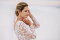 Portrait of a beautiful bride in the desert, blonde posing for a photographer on a wedding day