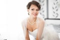 Portrait of beautiful bride with fashion veil posing at home at