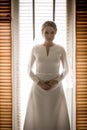 Portrait of beautiful bride posing against big window Royalty Free Stock Photo