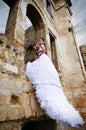 Portrait of a beautiful bride under the ruins arch
