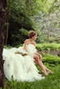 Portrait of a beautiful bride woman sits in a profile and looks into the distance.