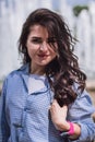 Portrait of a beautiful brunet girl touching her thick wavy hair. Royalty Free Stock Photo