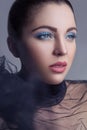 Portrait of beautiful brunette fashion model with black veil and blue makeup on silver black bakground Royalty Free Stock Photo