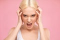 Portrait of a beautiful brunette girl with healthy clean skin and fresh makeup. She screams and gets angry