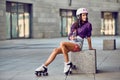 Portrait of beautiful brunette girl in helmet in urban skate park