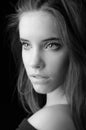 Portrait of the beautiful brunette girl isolated on black background in black and white Royalty Free Stock Photo